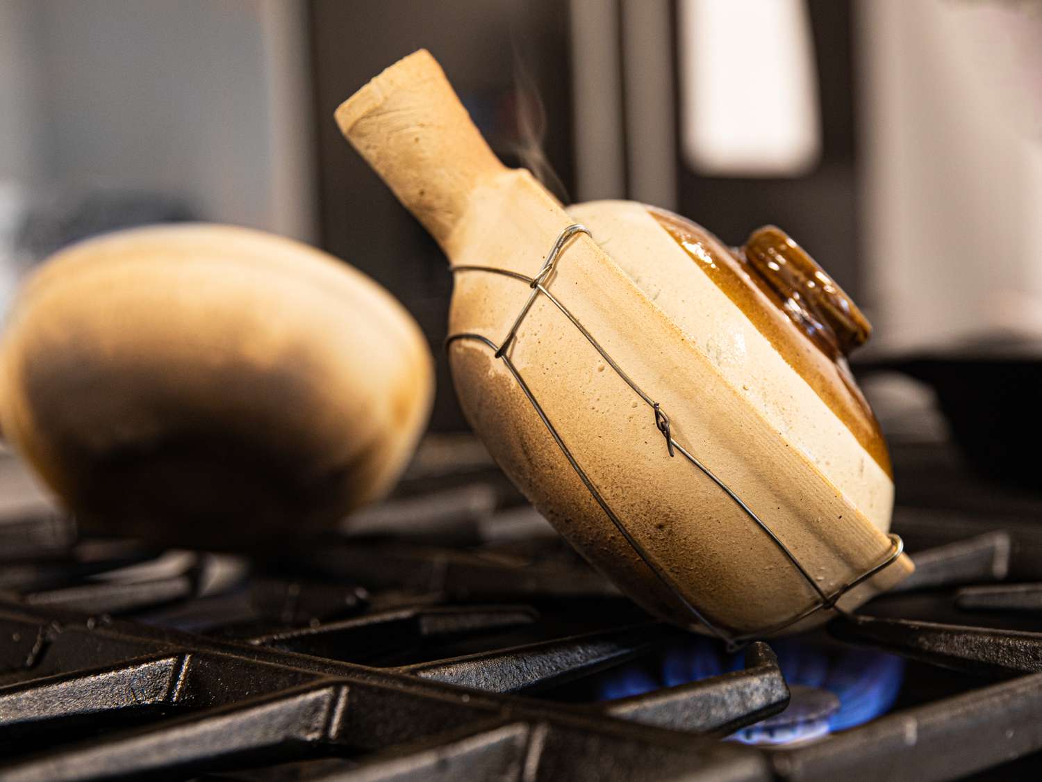 Cantonese clay pot rice tilted on a burner.