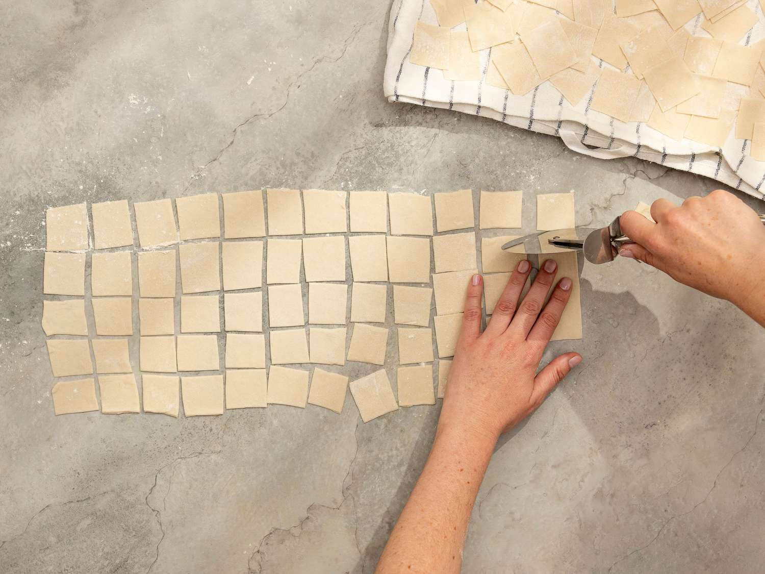 Overhead view of cutting noodles from dough