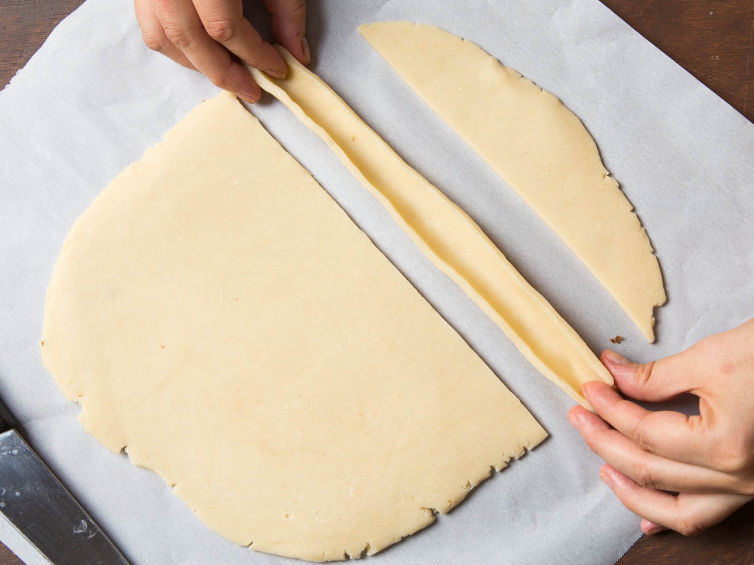 Folding the cookie dough strips lengthwise to make a trough.