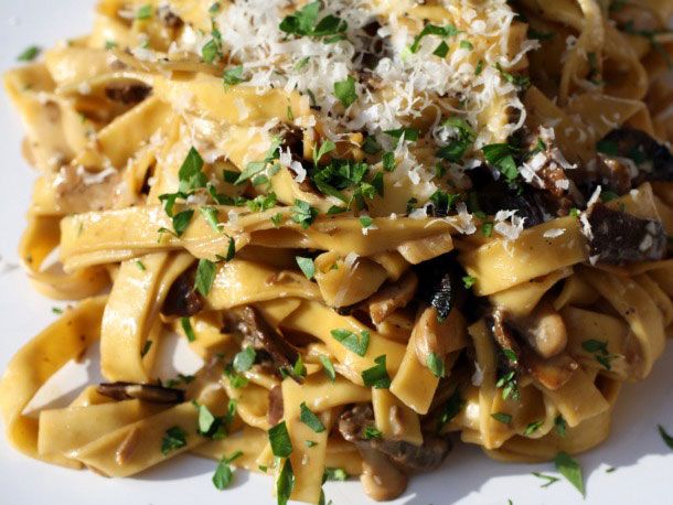 tagliatelle with porcini and crème fraîche topped with grated cheese and fresh thyme
