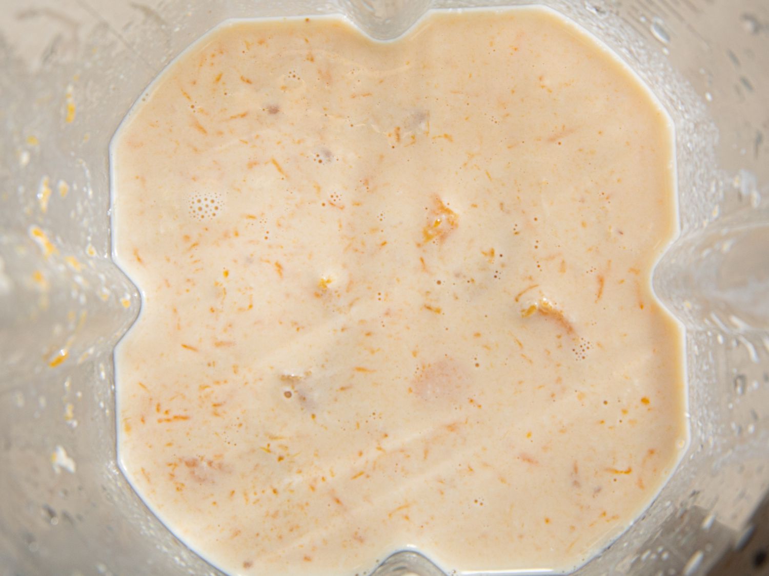 Overhead view into the blender after squash milk mixture has been blended