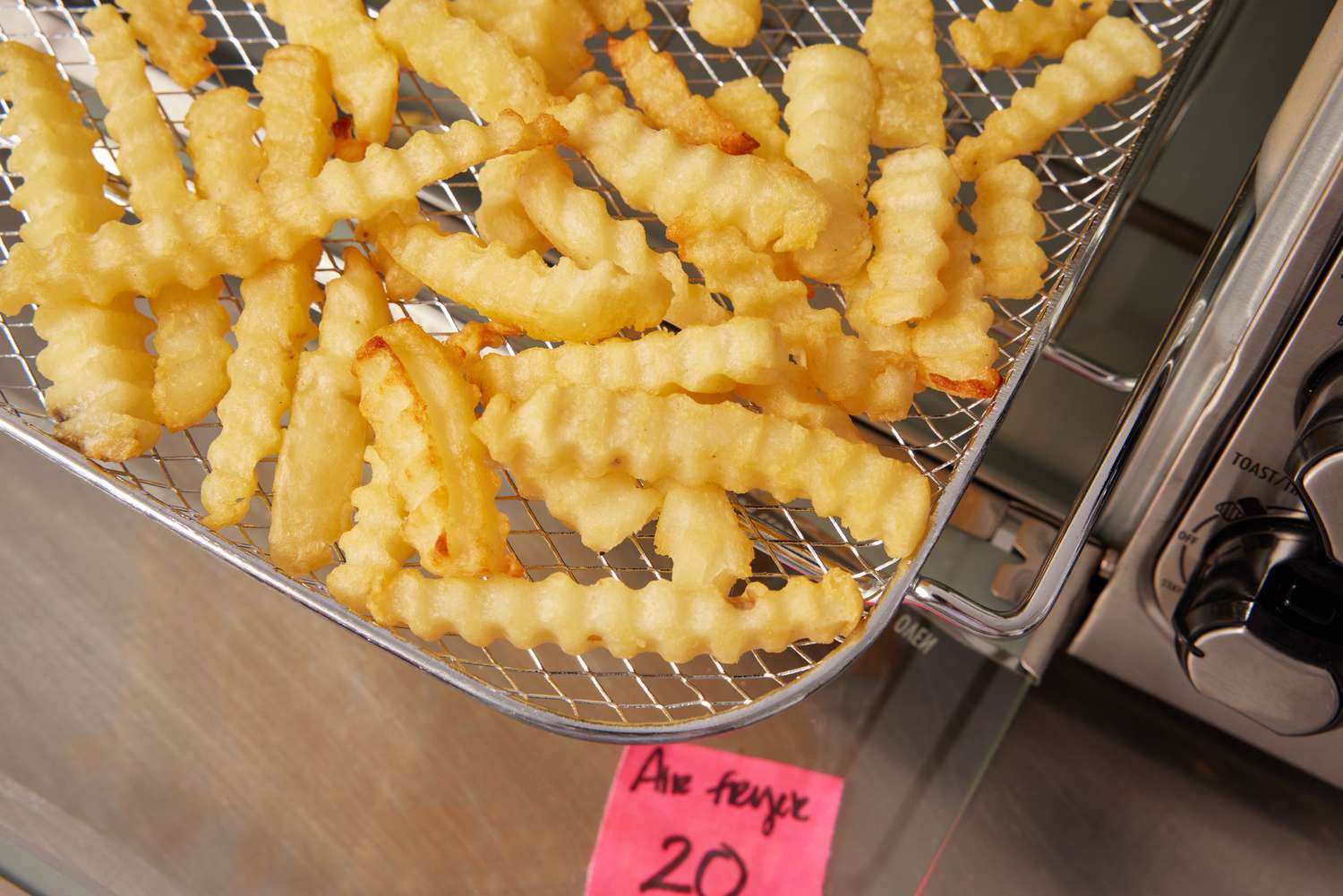 A closeup look at fries in an air fryer toaster oven