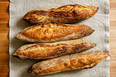 俯视of 4 baguettes on a grey table runner