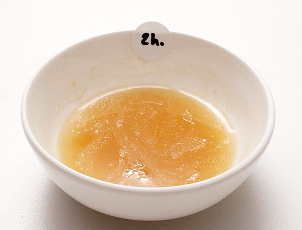 一小碗有明胶斑点的猪肉汤，上面的标签写着两个小时。