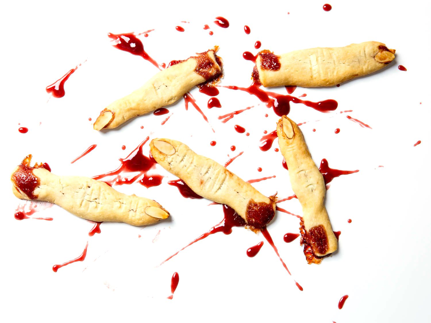 Witch finger shortbread cookies with raspberries jam splattering to resemble blood.