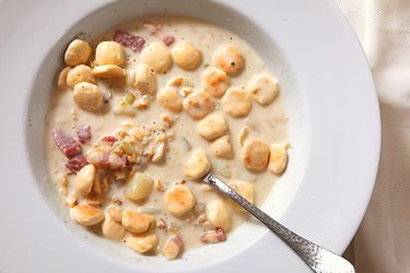 overhead shot of a bowl of New England clam chowder with oyster crackers