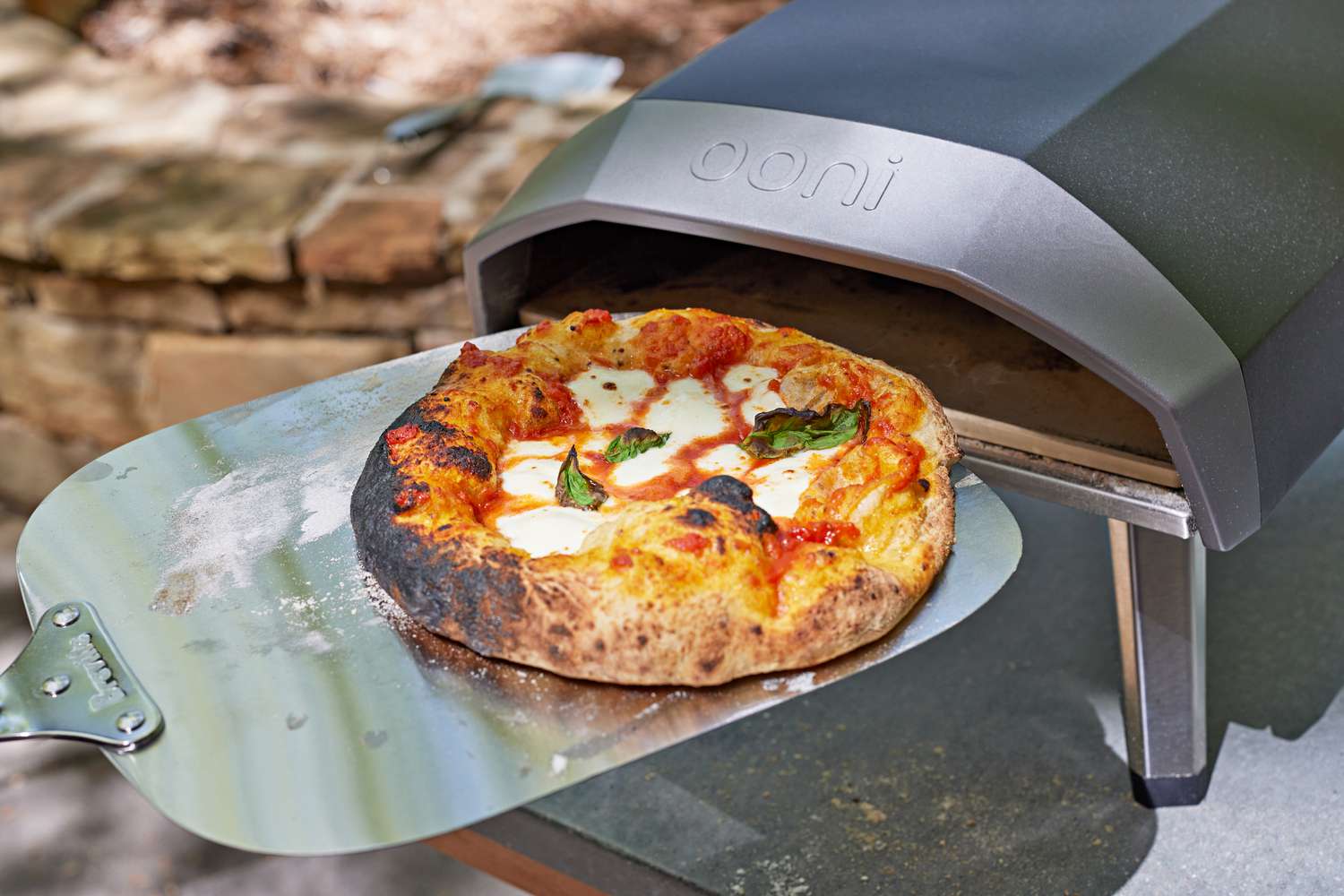 A finished pizza from the Ooni Koda 12 on a metal pizza peel