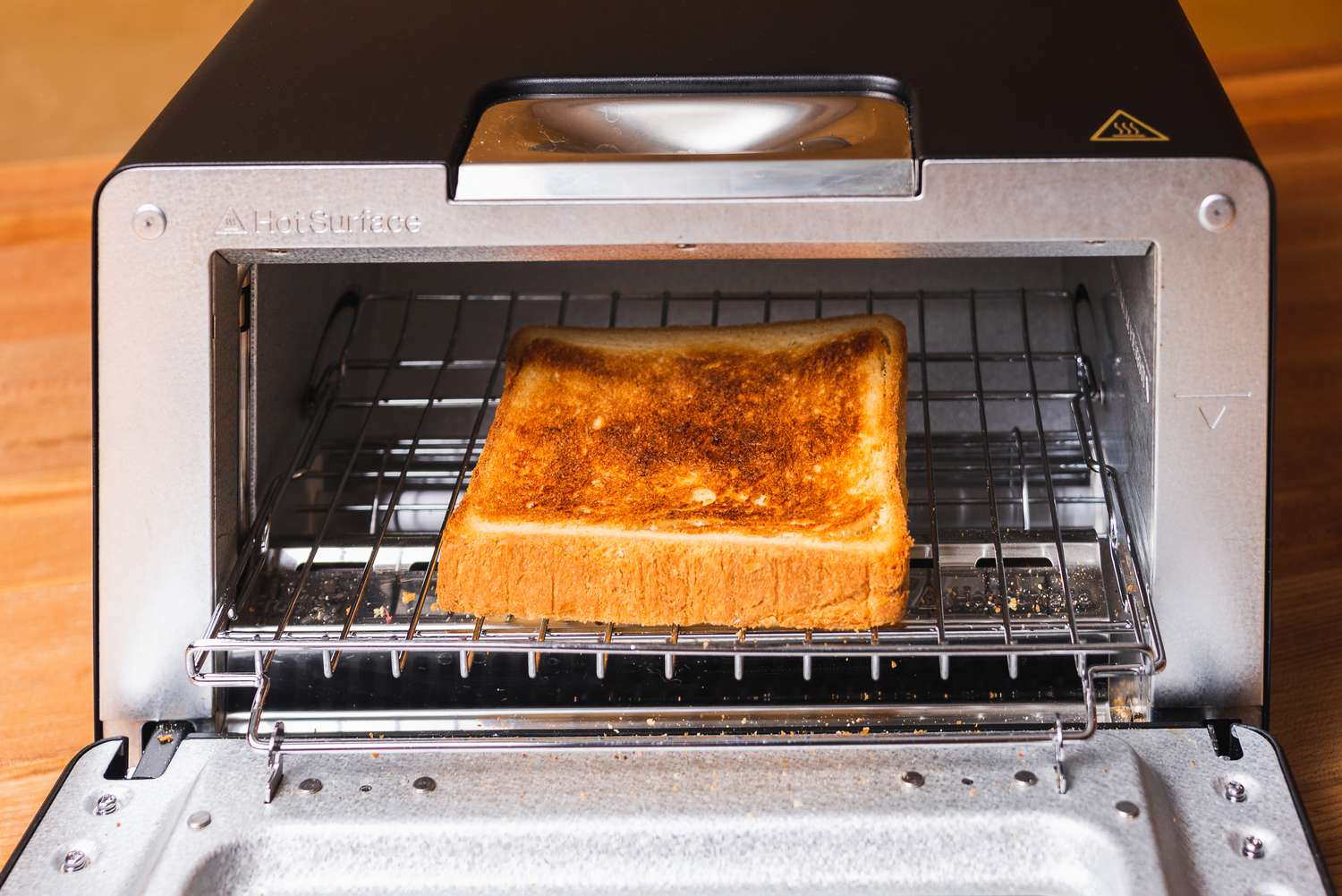 a piece of toast in the center of the Balmuda's oven rack