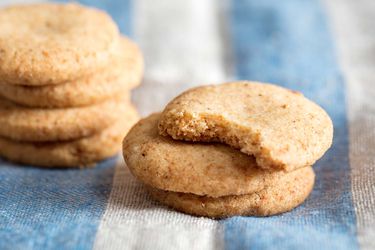 Short stacks of brown butter shortbread with one bite taken from first cookie