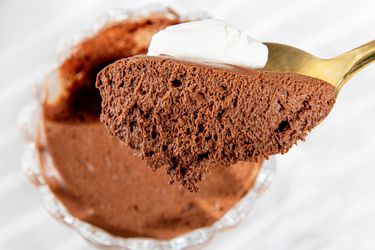 Side angle view of a spoon lifting up chocolate mousse