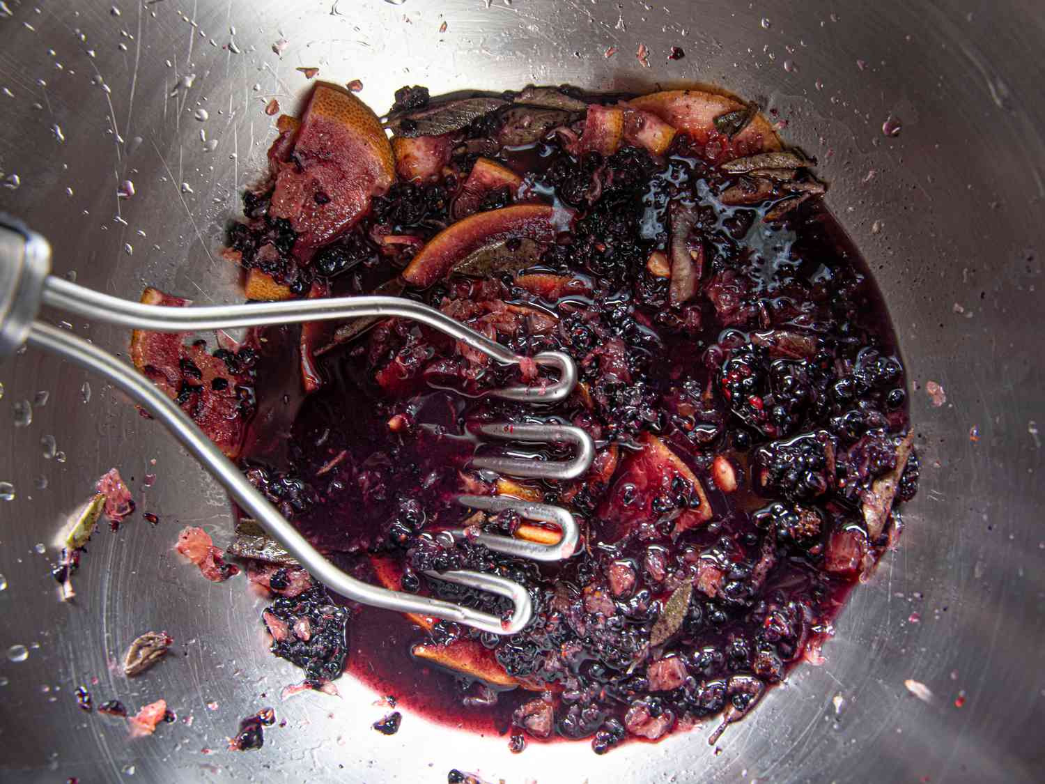 Muddling fruit in bowl