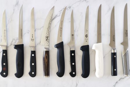 boning knives on a marble countertop