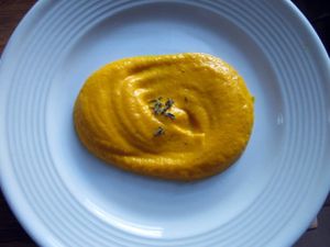 A dollop of butternut squash puree on a plate.