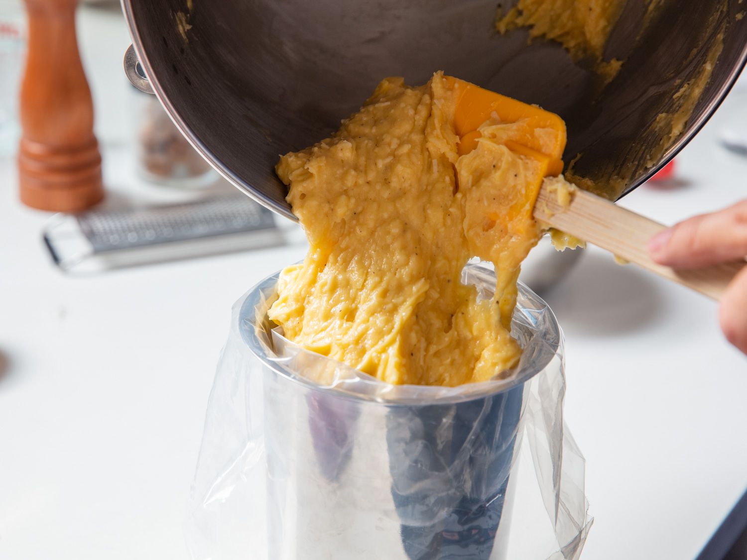 Closeup of the choux paste being transferred to a pastry bag.