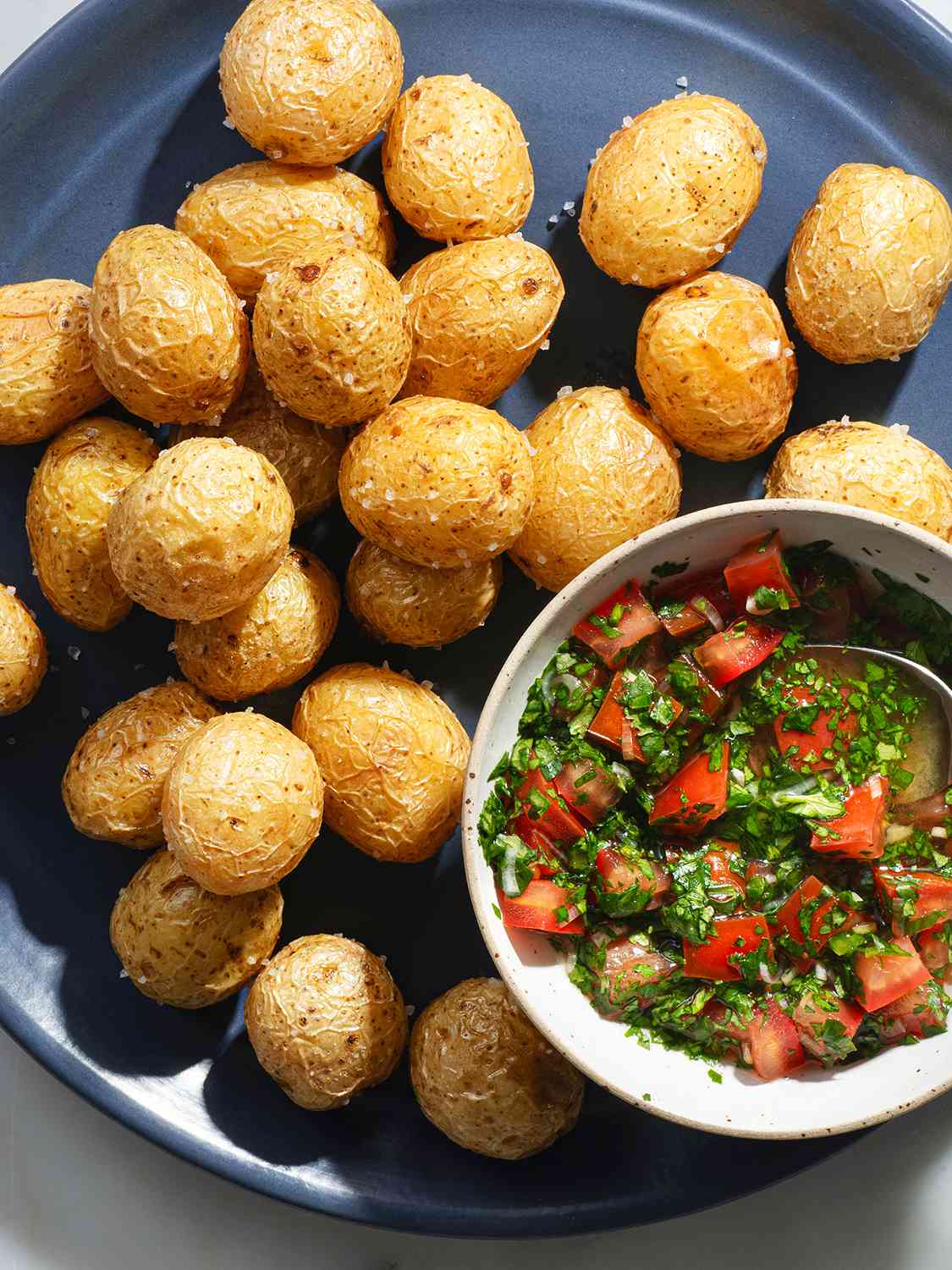 Fried papas criollas on a plate with ajÃ­.