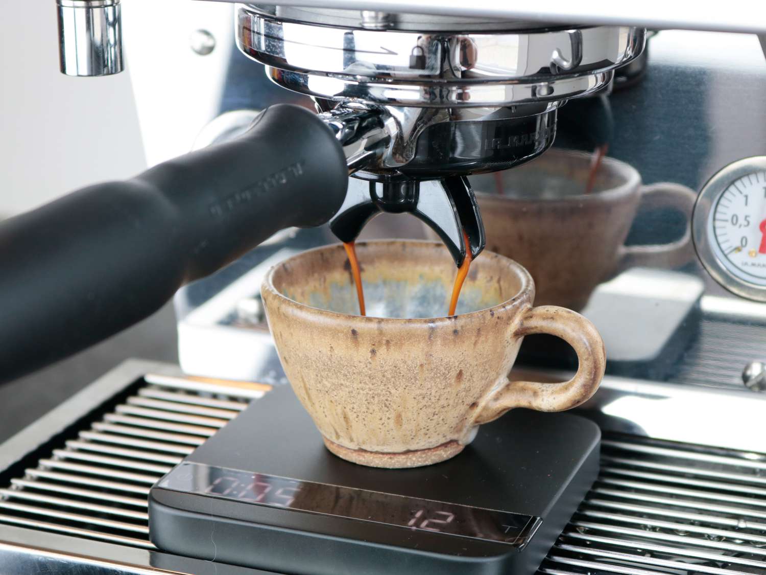 an espresso shot flowing smoothly off the spouts of a portafilter