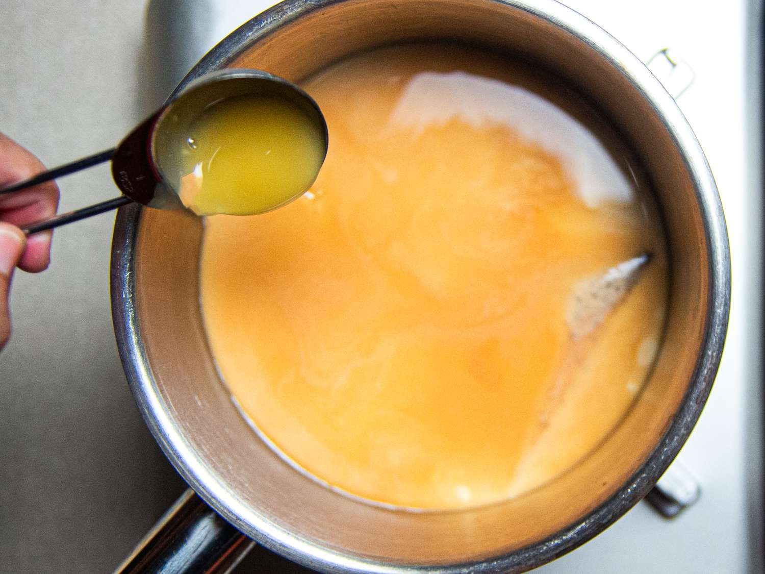 Adding condensed milk to pot