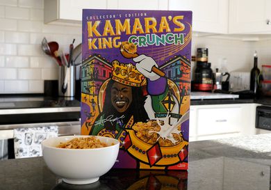 Box of Kamara's King Crunch cereal on a counter with a bowl filled with the cereal in front of it