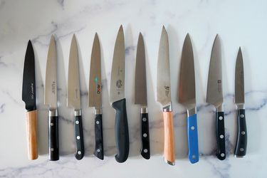 the lineup of petty knives we tested on a marble countertop