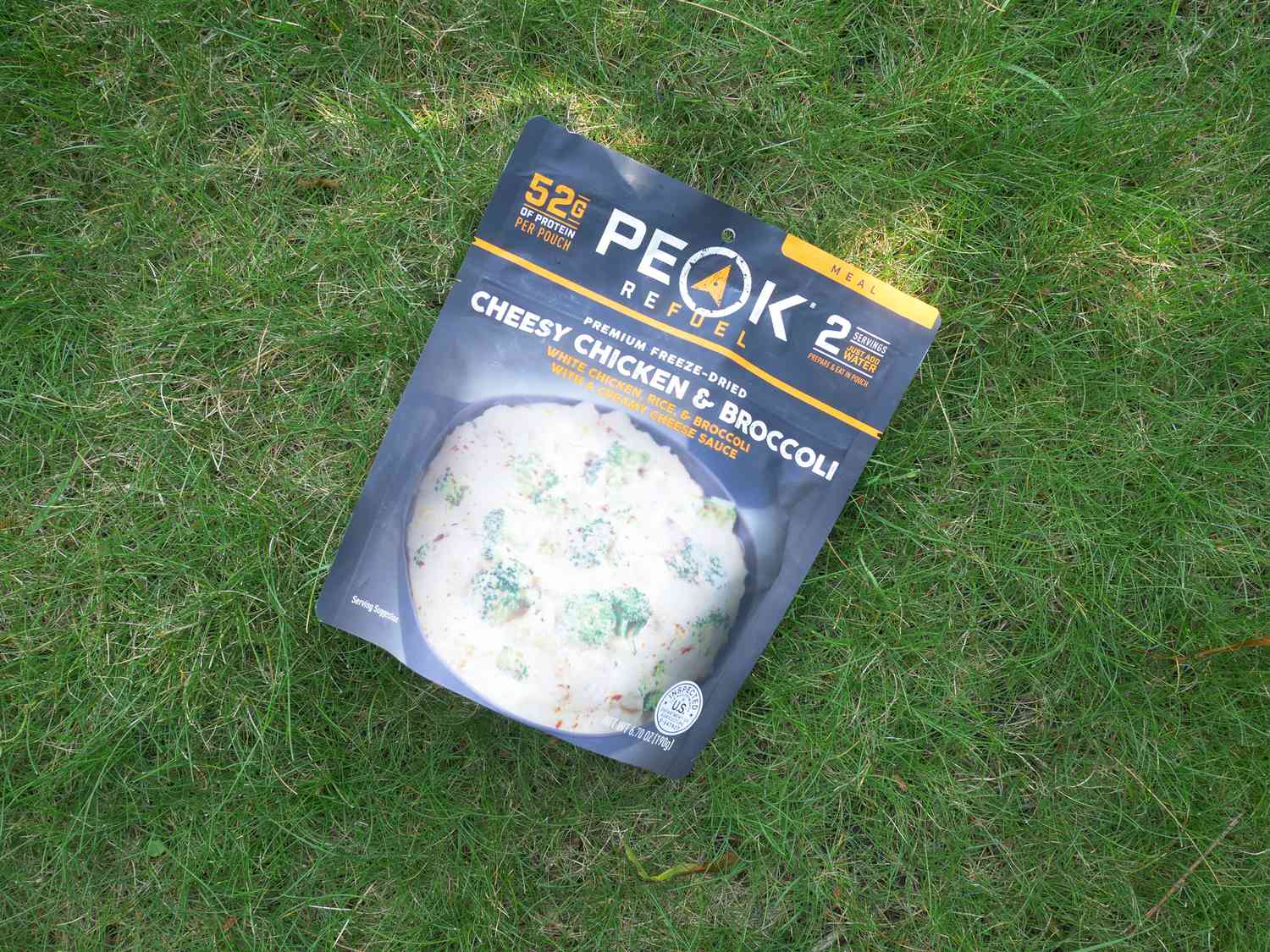 peak refuel cheesy chicken and broccoli pouch on lawn