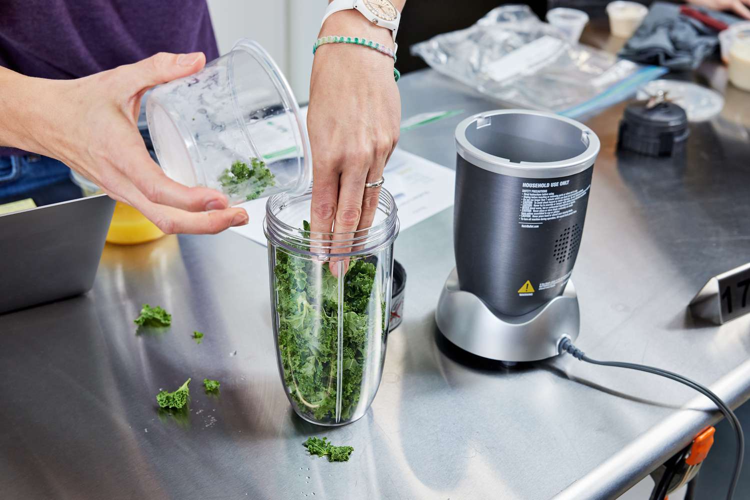 putting kale into the nutribullet pro blender jar