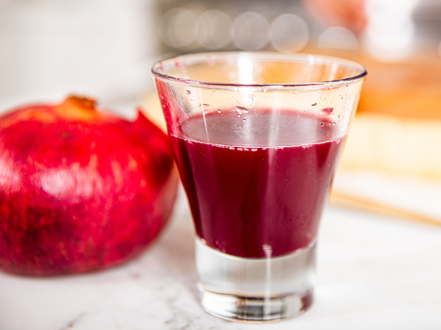 Side view of a glass of pomegranate juice