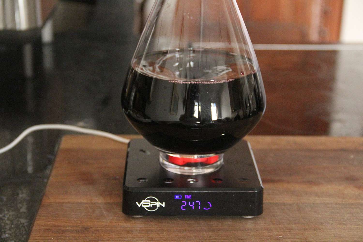 a closeup of an electric wine decanter spinning wine around