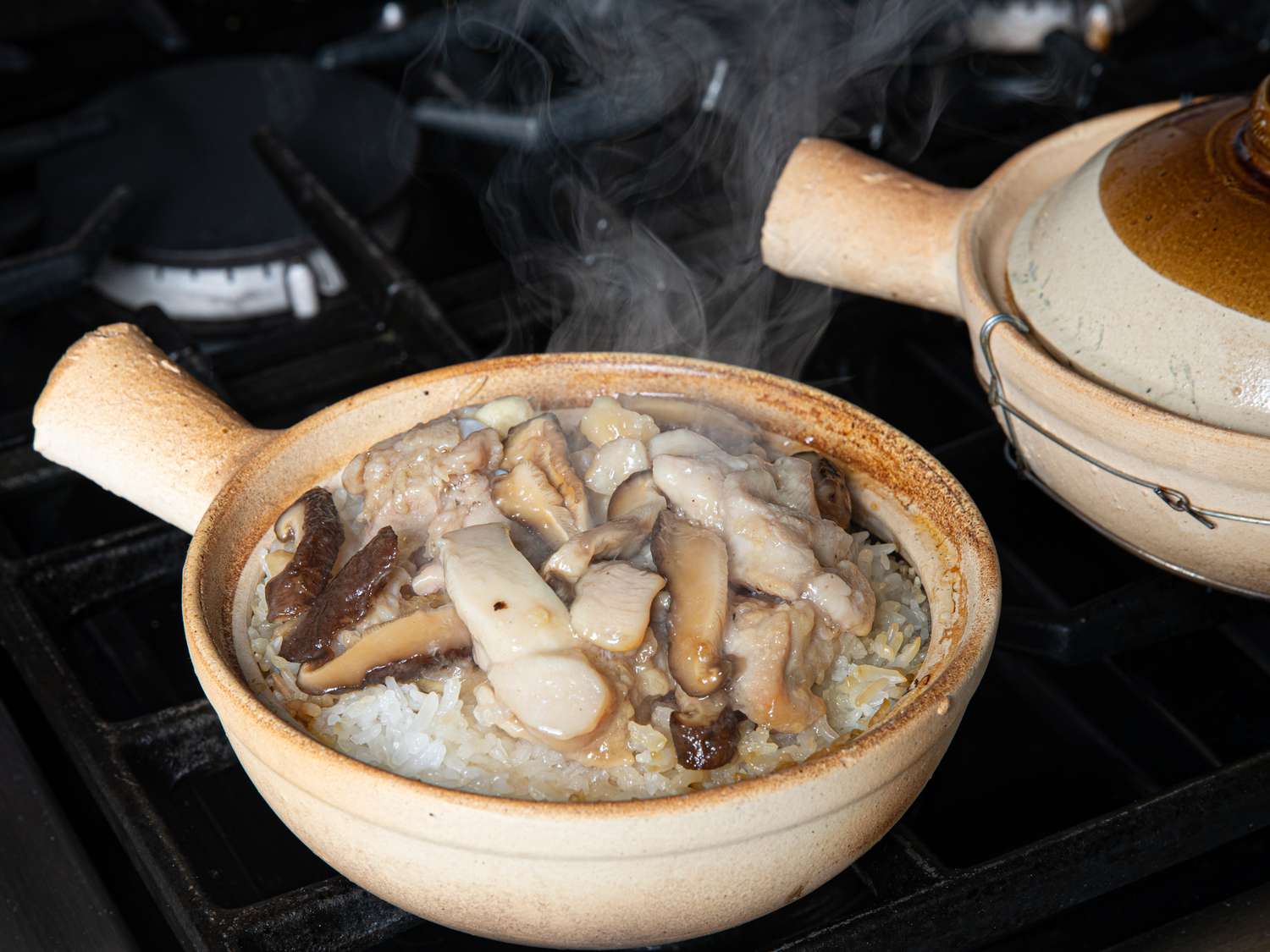 Velveted chicken and mushrooms on top of Cantonese clay pot rice.