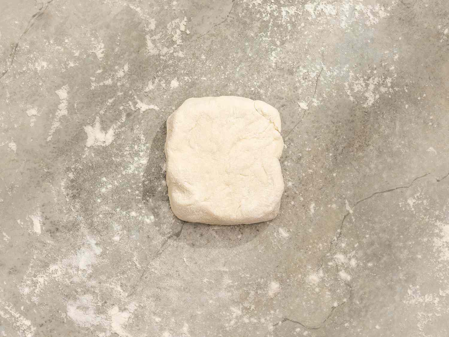 Overhead view of one section of dough formed into a 3-inch square