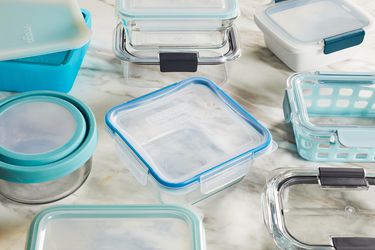 several food storage containers on a marble surface