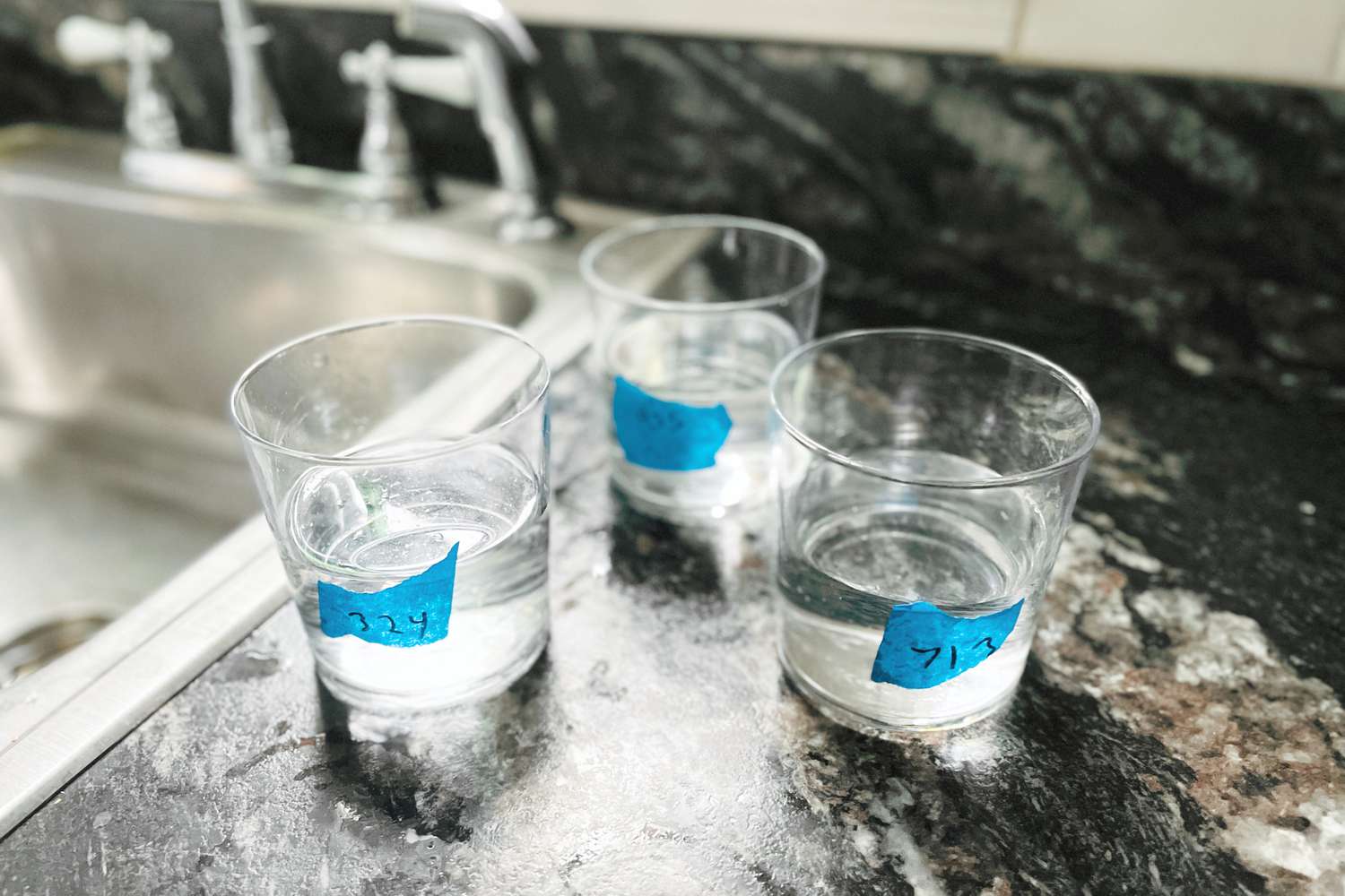 glasses of water with labels as part of the blind tasting