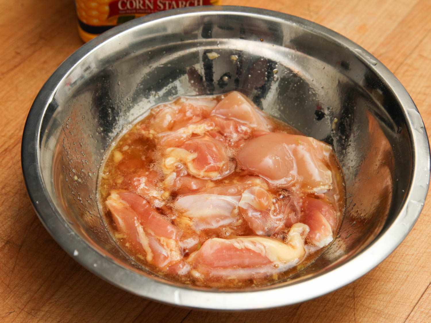 Boneless chicken thighs in a thin marinade before frying.