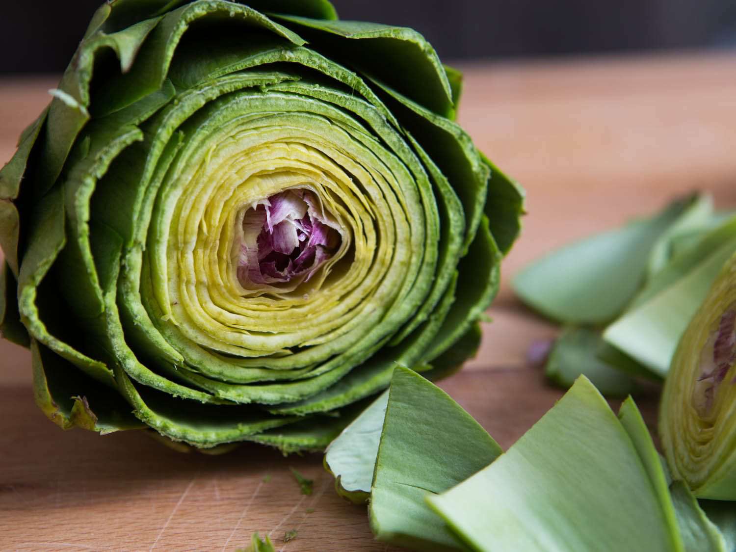 Close-up of a trimmed artichoke, with cut-off leaves (bracts) on the right hand side of the image.