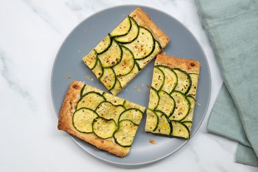 Three slices of puff pastry zucchini tart on a plate