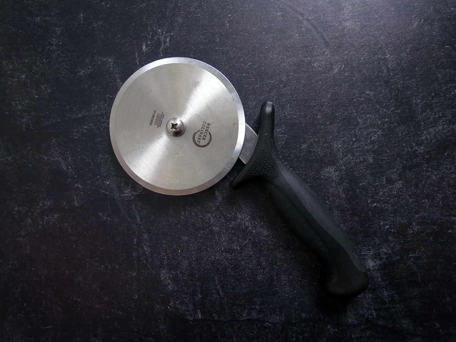 Mercer Pizza Cutter on a black backdrop