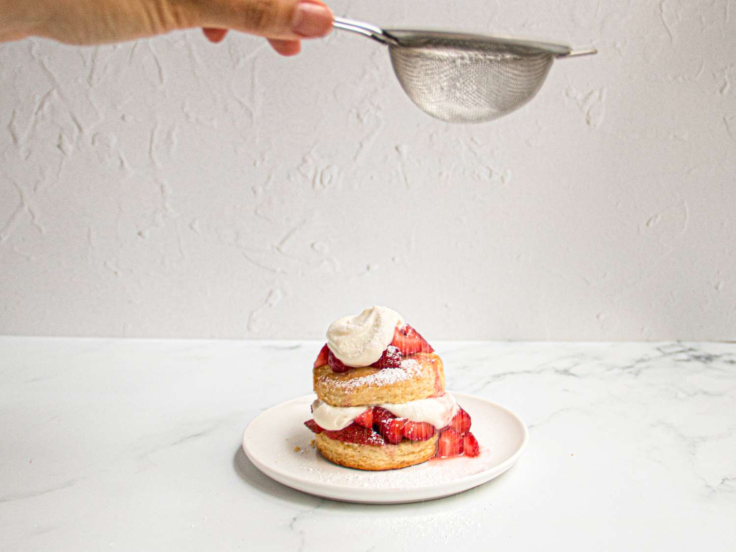 Dusting strawberry shortcake with. sugar