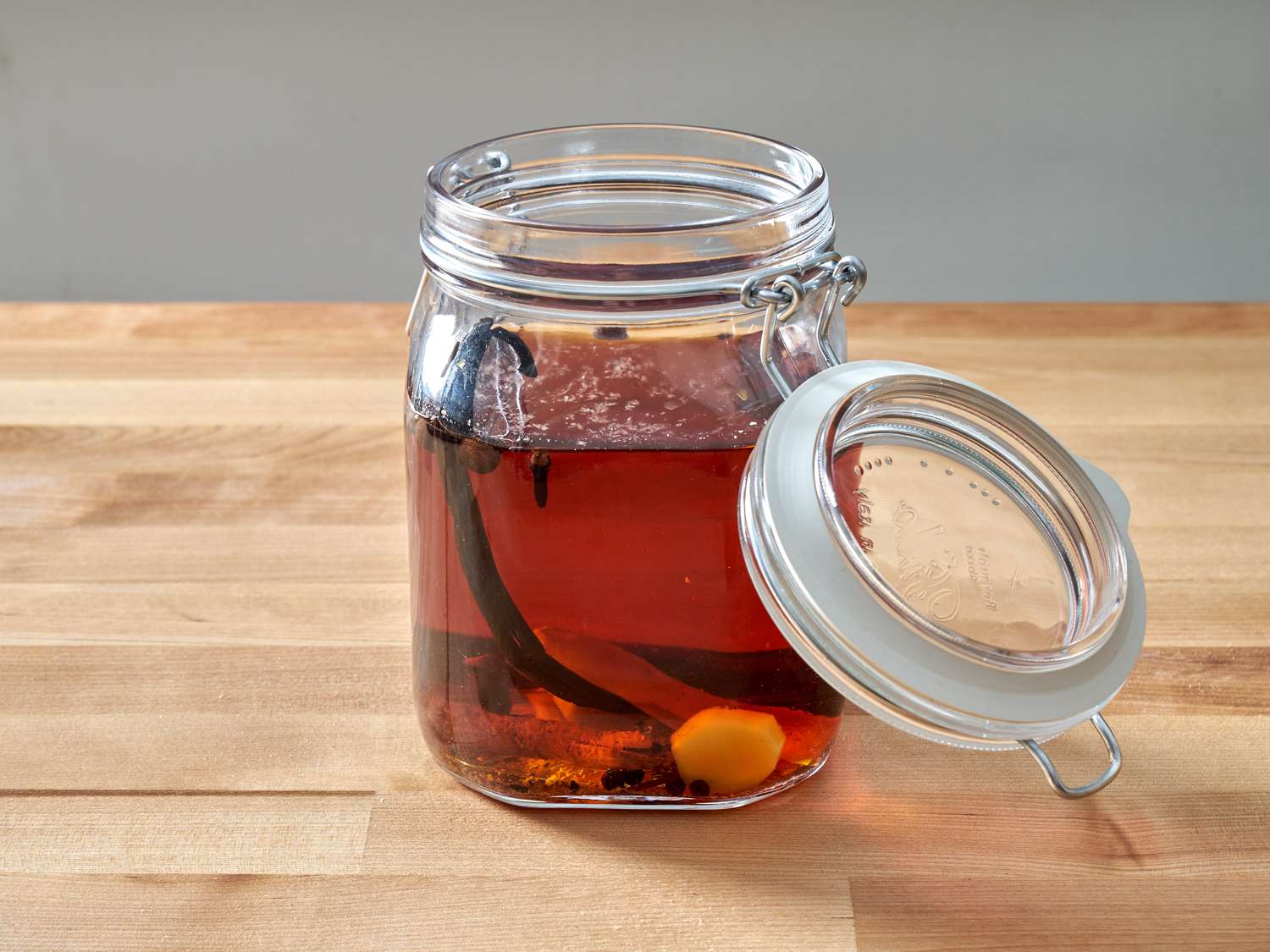 a jar filled with ingredients to make spiced rum