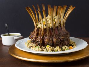 A roasted rack of lamb topped with couscous stuffing.