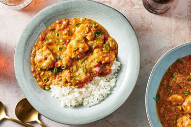 Shrimp Ã©touffÃ©e in a soup plate with rice and thinly sliced scallions