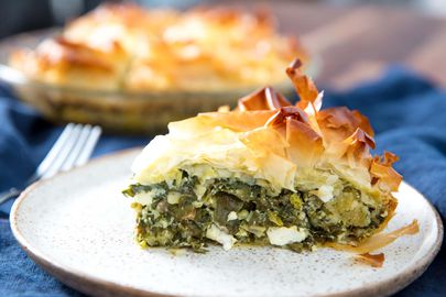 A slice of homemade spanakopita with large chunks of feta inside