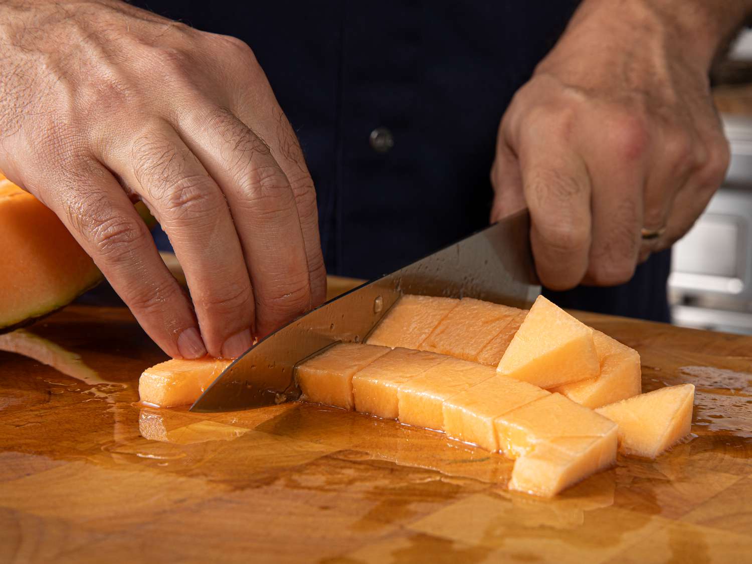 Side view of cutting melon into cubes