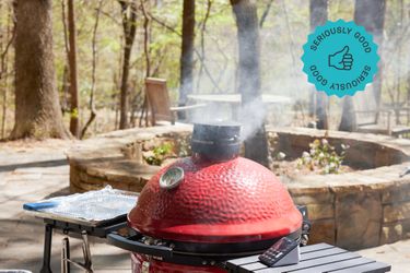 A kamado cooker billowing steam out of the top of its lid