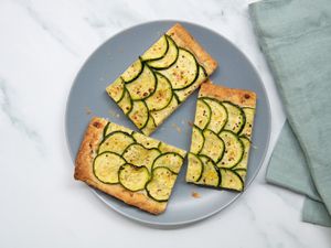 Three slices of puff pastry zucchini tart on a plate