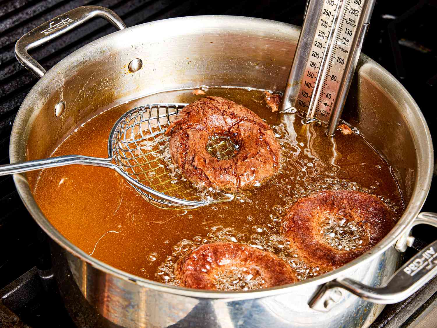 Overhead view of frying doughnuts in oil