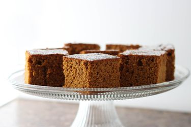 Squares of Gluten-Free Pumpkin Gingerbread on a glass cake stand