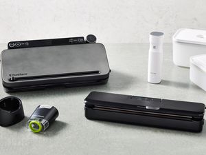 an array of handheld and countertop vacuum sealers on gray countertop