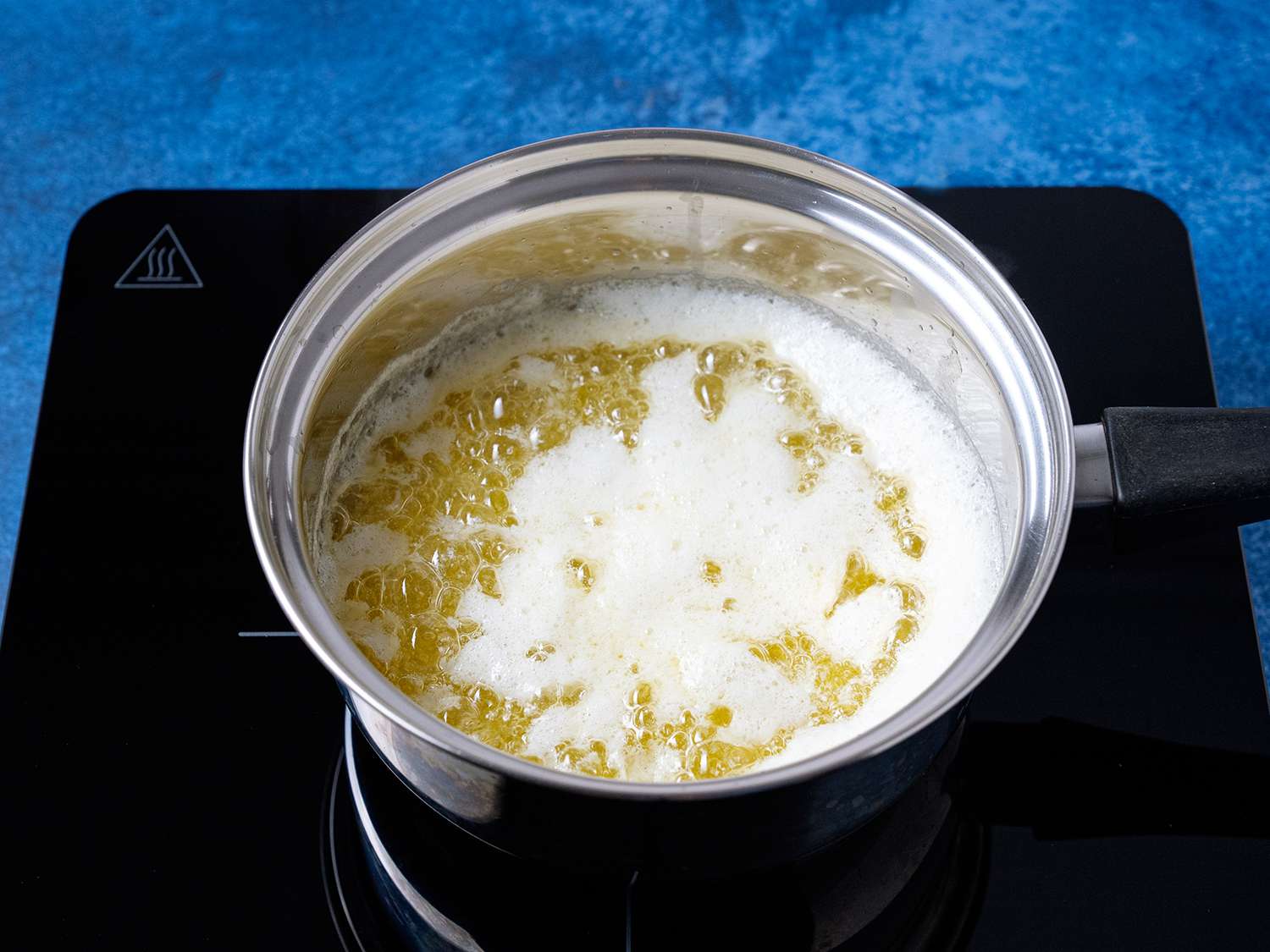一锅煮熟的黄油，上面放着白色牛奶蛋白