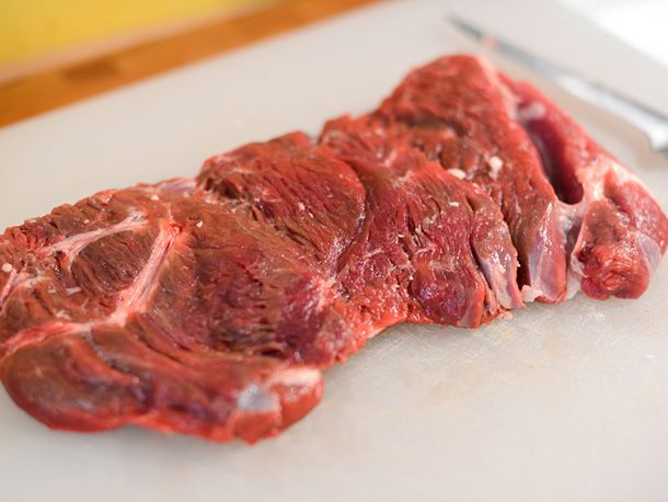 Raw lamb on a cutting board.