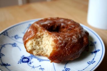 A homemade buttermilk cake doughnut on a blue and white plate