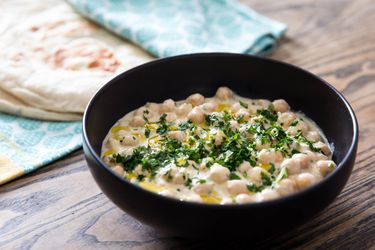 bowl of hummus masbacha with pita bread